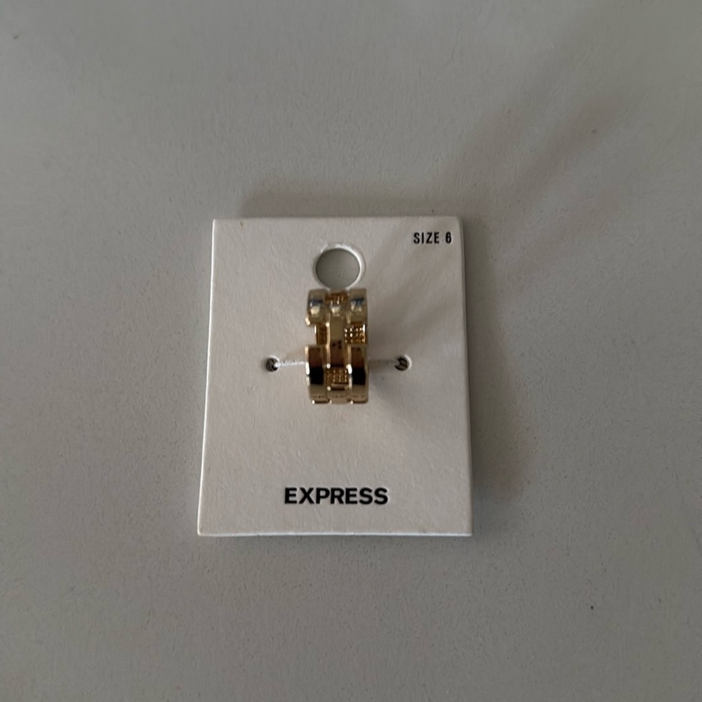 Express gold tone ring. Comfortable in size 6 New